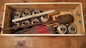 Antique Golf hole cutter with cups and flags.